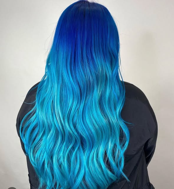 Vivid blue ombre colour on long wavy hair